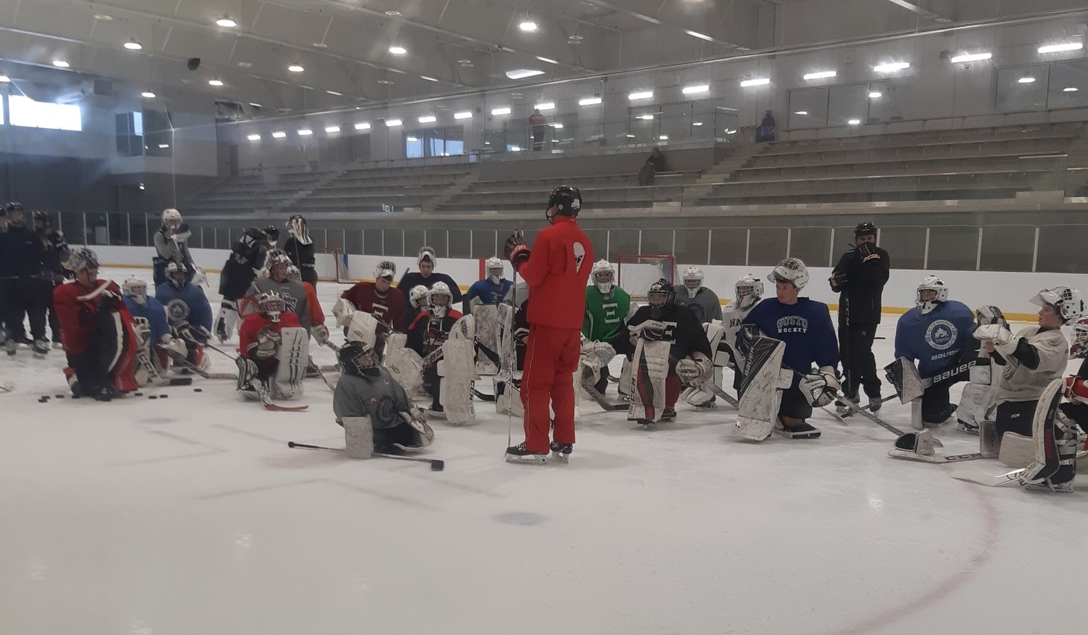 Maxime Ouellet instructing goalies on-ice at hockey camp